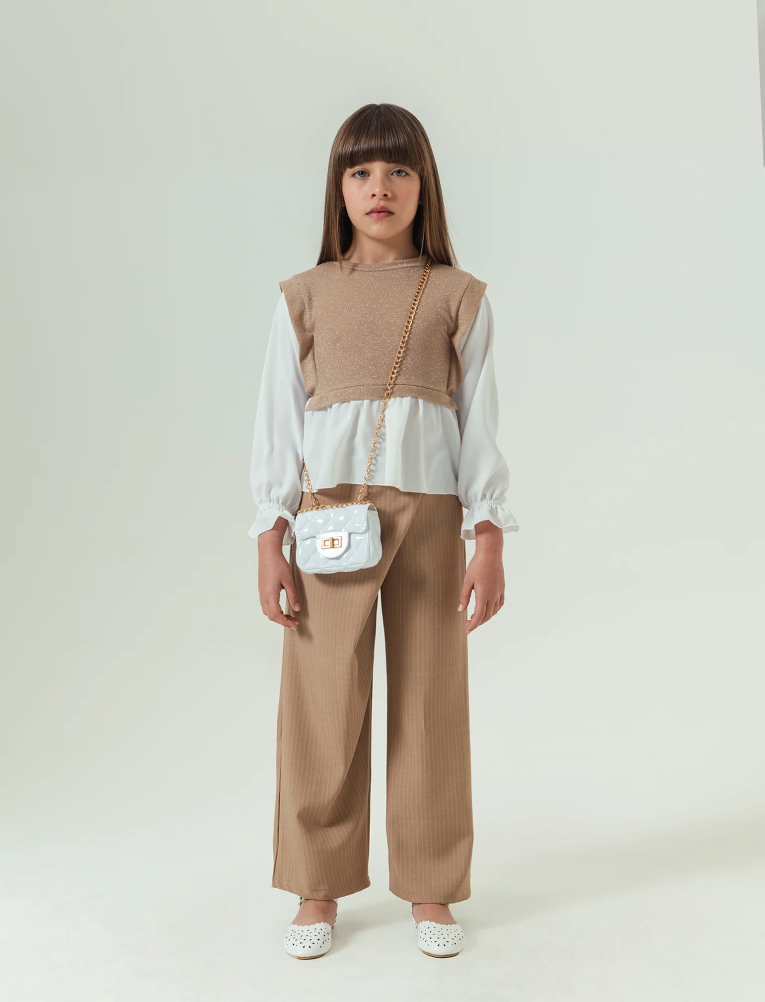 Pantaloni eleganti da bambina in tessuto gessato. - Beige